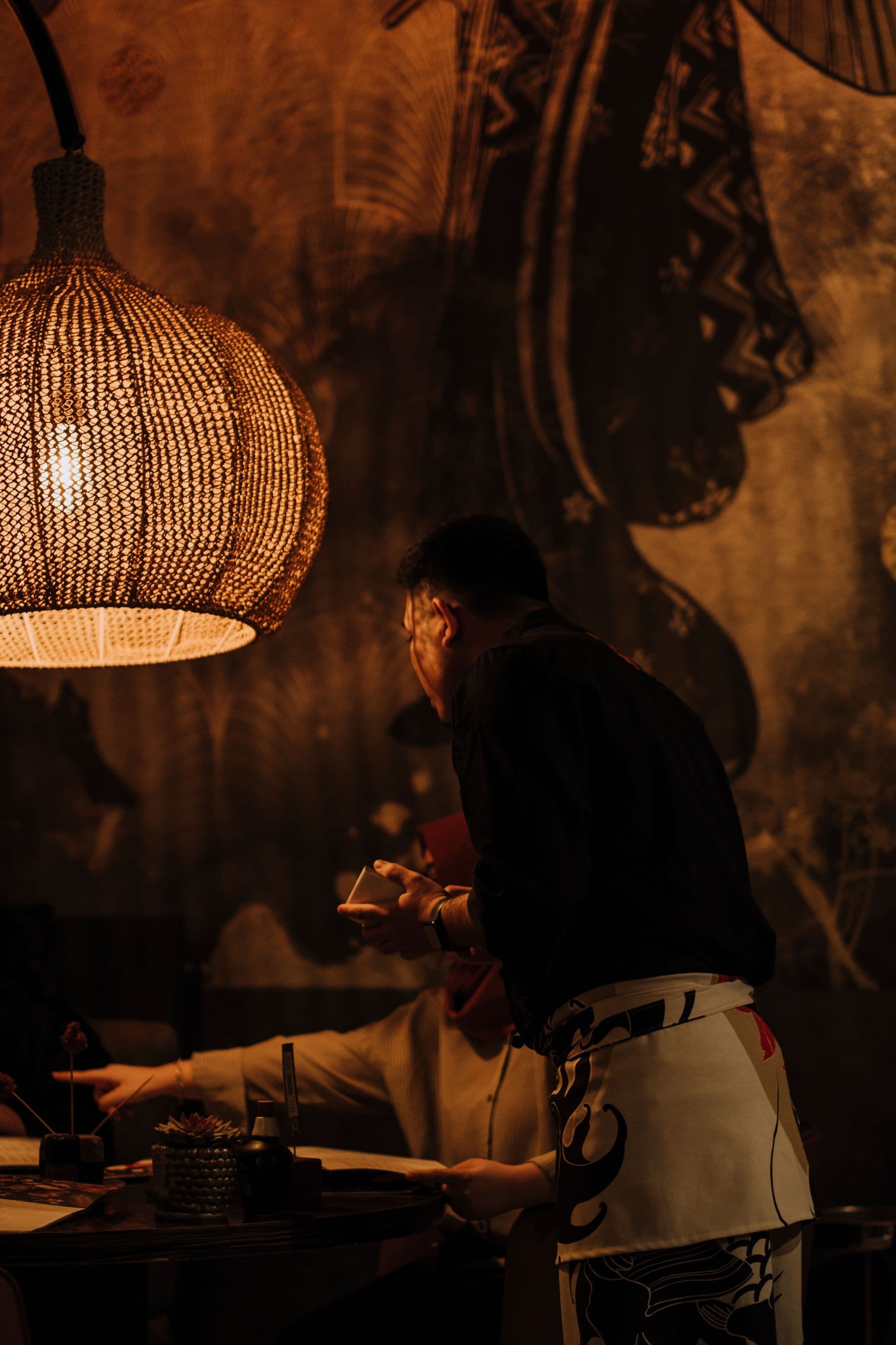 A waiter serving guests in a restaurant